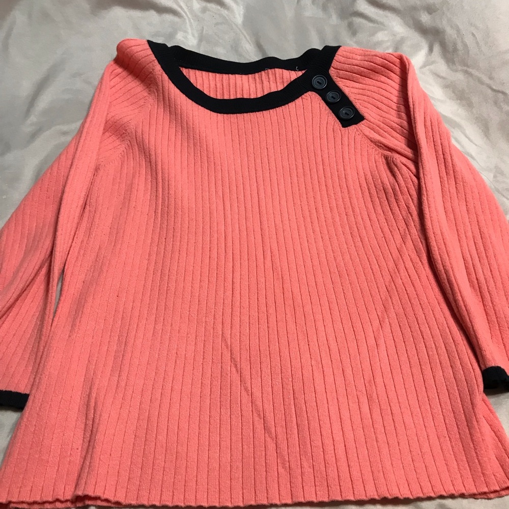 Coral and black sweater.